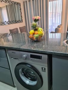 a bowl of fruit on top of a washing machine at Lerewa in Gaborone +21 photos