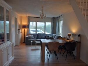a living room with a table and a couch at molenpad in Meliskerke