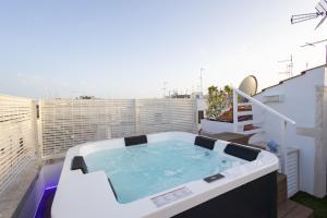 a hot tub on top of a balcony at Suite Arco Galera 63 in Putignano