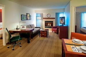 a room with a living room with a couch and a table at Residence Inn Sioux Falls in Sioux Falls