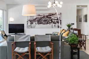 a living room with a couch and a tv at Xitaka Country House - Modern Large Great Views in Torres Novas
