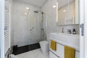 a white bathroom with a shower and a sink at Xitaka Country House - Modern Large Great Views in Torres Novas +20 photos