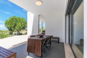 a dining room with a table and chairs on a patio at Xitaka Country House - Modern Large Great Views in Torres Novas