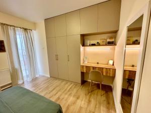 a bedroom with a desk and a bed and a mirror at All Green Loft with Amazing Views, With 2 Balconies and AC in Tbilisi City