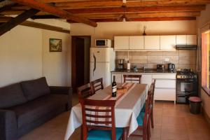 a kitchen and dining room with a table and a couch at Complejo BenjaLuna in San Rafael