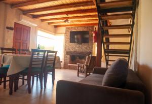 a living room with a couch and a table and a fireplace at Complejo BenjaLuna in San Rafael