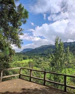 a view of a valley from a wooden fence at Casa Campo Loma Larga in La Palma