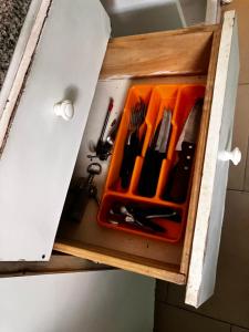 a cupboard with utensils in it at DuplexNico in Santa Teresita