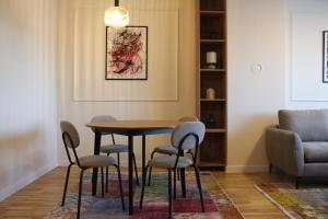 a dining room with a table and chairs at Sun Apartments in Pristina