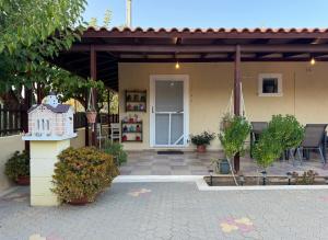 patio con tavolo e casa di Golden Horizon Retreat, tranquil atmosphere next to the sea! a Gournes