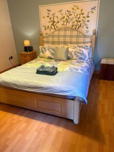 a bed in a bedroom with at Garden cottage in South Collingham