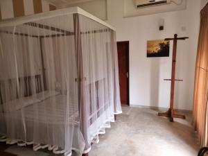 a room with a crib with a cross on the wall at GalleRetreat in Galle