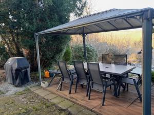 a patio with a table and chairs under a canopy at Ferienhaus Lichtblick in Kurort Gohrisch