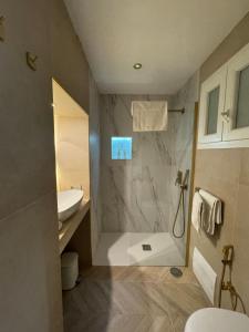 a bathroom with a shower and a sink and a toilet at NapoliOn - Luxury Apartment in Naples +43 photos