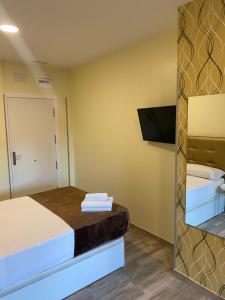 Postel nebo postele na pokoji v ubytování Hostal Oliver