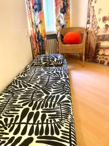 a bedroom with a zebra print bedspread and a chair at Cozy and peaceful Punavuori in Helsinki