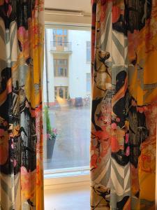 a window with a curtain with a dog on it at Cozy and peaceful Punavuori in Helsinki