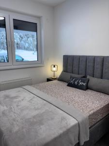 Ένα ή περισσότερα κρεβάτια σε δωμάτιο στο Bjelasnica Comfort