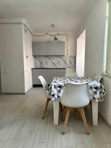 a dining room with a table and chairs at Квартира in Gyumri