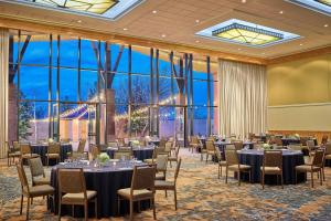 a ballroom with tables and chairs in a room with large windows at The Westin Westminster in Westminster