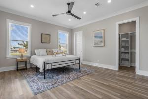a bedroom with a bed and a ceiling fan at Beach Retreat in Gulfport