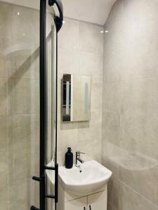 a bathroom with a sink and a shower at Little Teagues in East Grinstead