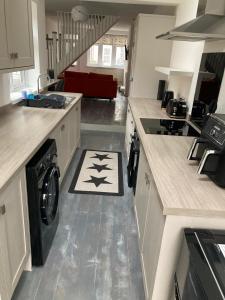 a kitchen with a washer and dryer on the floor at White Sands, NEWLY renovated central 2 bed house near Cleethorpes beach and all amenities in Cleethorpes