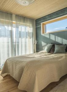 a bedroom with a large bed and a window at Luxury Privat Villa Merellä in Kalajoki