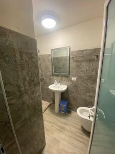a bathroom with a shower and a sink at Vila Loris in Voskopojë +27 photos