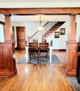 a dining room with a table and a staircase at Warrensburg, UCM, Whiteman AFB, KC Chiefs, Wedding Venue, Bring your Pet, Secluded Farmhouse in Centerview