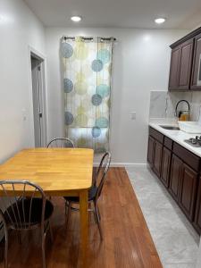 a kitchen with a table and chairs and a sink at Pretty apartment NY in 10 minutes in Union City