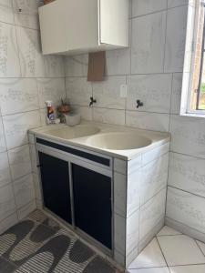 a bathroom with a sink and a white cabinet at 130m2 de área para sua família, com ar cond E vaga in Bom Jesus da Lapa +34 photos