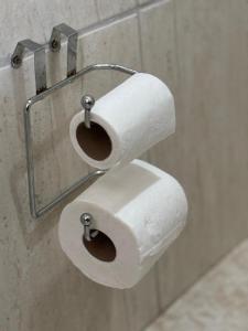 two rolls of toilet paper hanging on a wall at 130m2 de área para sua família, com ar cond E vaga in Bom Jesus da Lapa