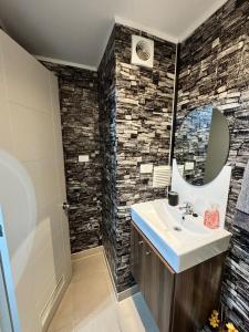 a bathroom with a sink and a mirror at Furnished apartment Puerto Montt in Puerto Montt