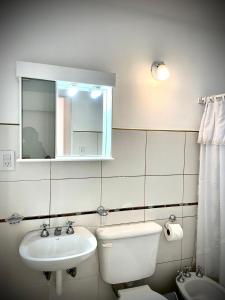 a bathroom with a sink and a toilet and a mirror at Delicado departamento en Formosa in Formosa