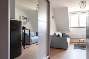 a living room with two couches and a refrigerator at Studio Bele Staze Central in Brzeće