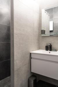 um banheiro com pia branca e espelho em Studio Bele Staze Central em Brzeće