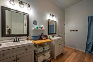a bathroom with two sinks and two mirrors at Entire Home! Fantastic Kitchen! 3 Full Baths in Mead +41 photos