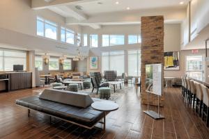 a lobby with a couch and tables and chairs at Residence Inn by Marriott Harrisburg North in Harrisburg