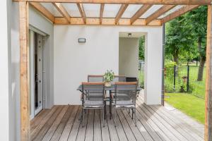 a patio with a table and chairs on a deck at Apartment Swim and Relax in Moravske-Toplice