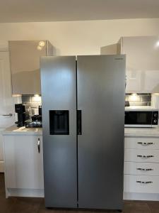 a large stainless steel refrigerator in a kitchen at Inverness Retreat in Inverness