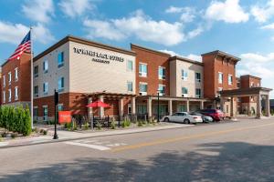 a hotel on a street with cars parked in front of it at TownePlace Suites by Marriott Louisville North in Jeffersonville
