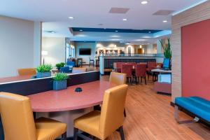 a dining room with a table and chairs at TownePlace Suites by Marriott Louisville North in Jeffersonville