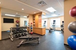 a gym with weights and exercise equipment in a room at TownePlace Suites by Marriott Louisville North in Jeffersonville