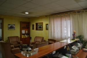 an office with a conference room with a table and chairs at Hostal Al-Qazeres in Cáceres