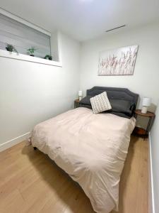 a bedroom with a large bed in a room at Modern Cozy Home in Vancouver +3 photos