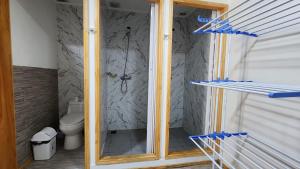 une douche en verre dans une salle de bains avec toilettes dans l'établissement Arriendo de Verano 4 dormitorios, à Valparaíso