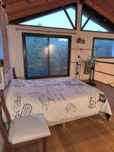 a large bed in a room with a window at Complejo Los Forasteros Unquillo in Unquillo +5 photos