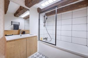 a bathroom with a shower and a sink at La Cabane Bellecour in Lyon +36 photos