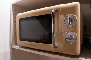 a microwave oven sitting on top of a shelf at La Cabane Bellecour in Lyon